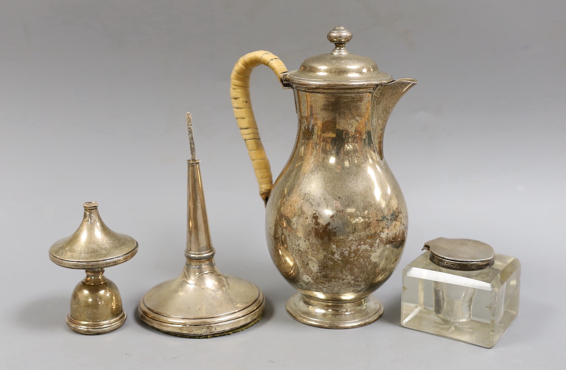 A late Victorian silver baluster hot water jug, with rattan handle, F.B. Thomas & Co, London, 1879, height 20.2cm, gross weight 12.9oz, together with a silver candlestick(a.f.) and a silver mounted glass inkwell (a.f.).